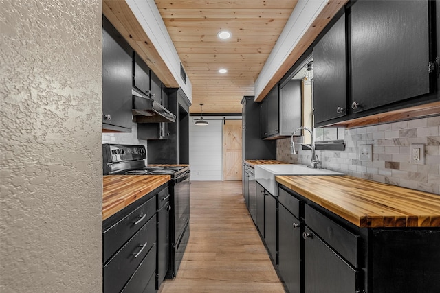 kitchen with black electric range oven, butcher block countertops, and dark cabinetry