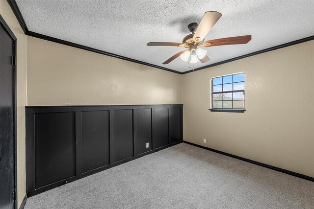 unfurnished room featuring a ceiling fan, a textured ceiling, and crown molding