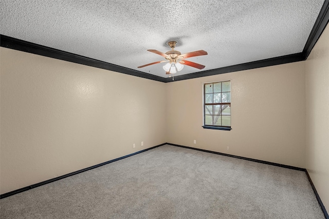 carpeted spare room featuring a textured ceiling, a ceiling fan, baseboards, and ornamental molding