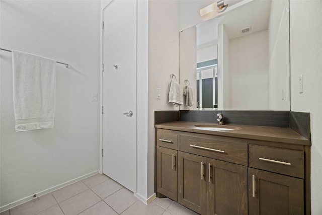 bathroom featuring visible vents, tile patterned floors, baseboards, and vanity