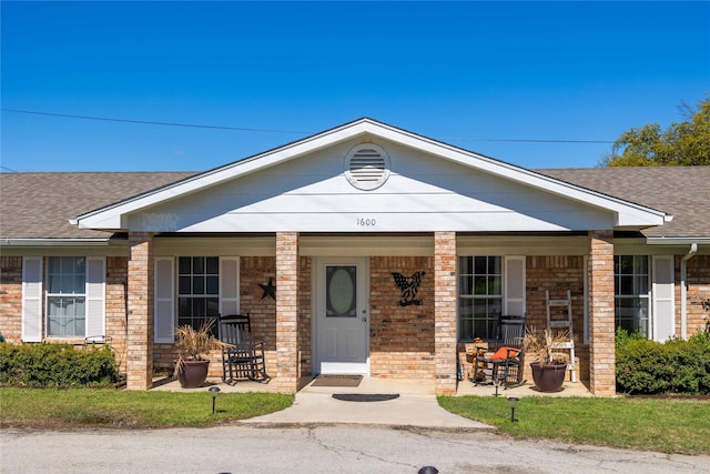 1600 Shaw Dr, Brownwood, TX 76801 - view of front of home featuring covered porch, a shingled roof, and brick siding
