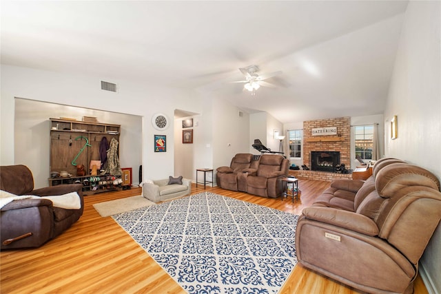 1600 Shaw Dr, Brownwood, TX 76801 - living room with a ceiling fan, visible vents, vaulted ceiling, a fireplace, and wood finished floors
