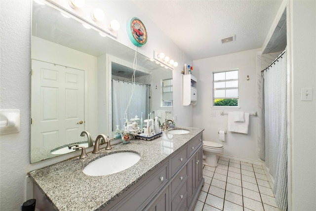 1600 Shaw Dr, Brownwood, TX 76801 - bathroom featuring toilet, visible vents, baseboards, and a sink
