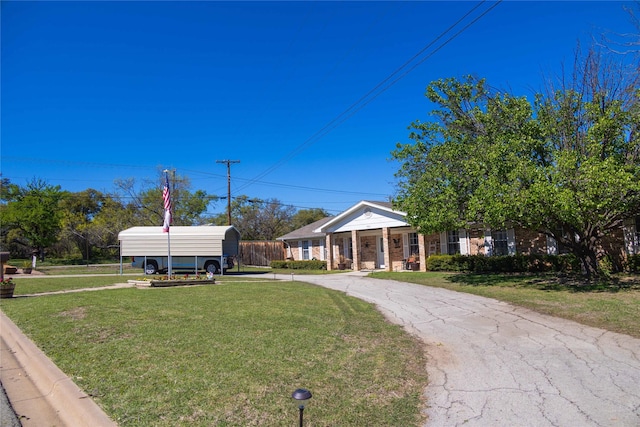 1600 Shaw Dr, Brownwood, TX 76801 - greek revival house with driveway, a detached carport, and a front lawn