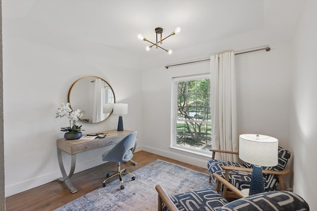 office area featuring baseboards, wood finished floors, and a chandelier