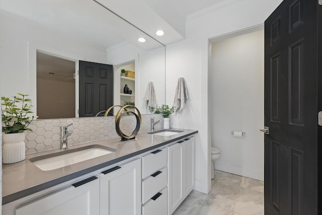 full bath with decorative backsplash, toilet, ornamental molding, and a sink