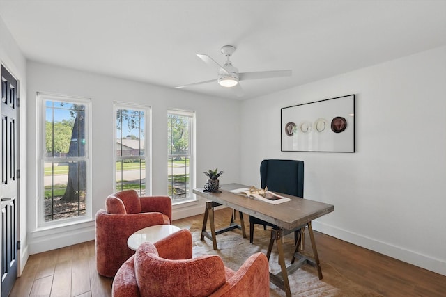 office area featuring wood-type flooring, a wealth of natural light, ceiling fan, and baseboards