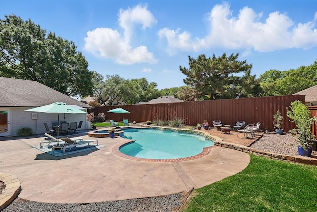 view of pool with a fenced backyard, a patio area, and a pool with connected hot tub
