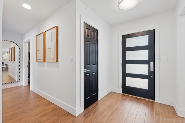 entrance foyer with light wood finished floors and baseboards