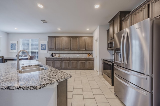 kitchen with visible vents, recessed lighting, a sink, appliances with stainless steel finishes, and light tile patterned floors