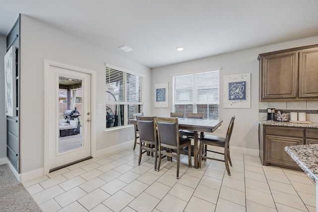 dining room featuring baseboards and light tile patterned floors