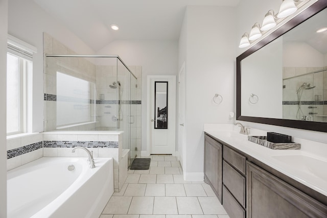 full bath with a garden tub, double vanity, tile patterned floors, a shower stall, and a sink