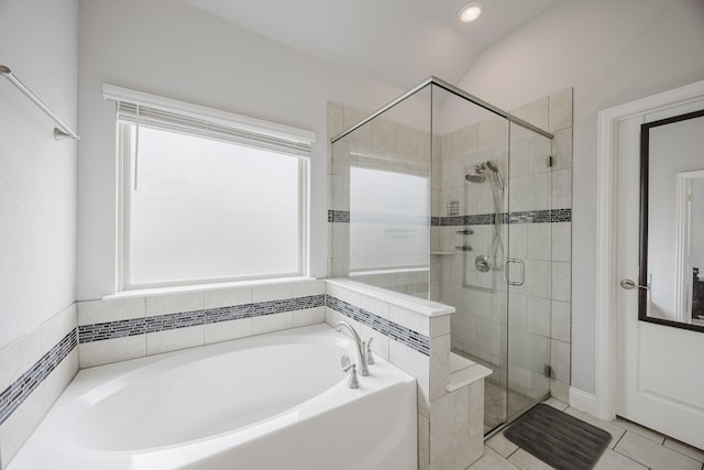 full bath featuring tile patterned flooring, a bath, and a stall shower