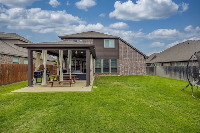 back of property featuring brick siding, a fenced backyard, a patio area, and a lawn