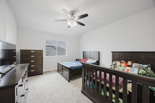 bedroom with a ceiling fan, light colored carpet, lofted ceiling, and visible vents