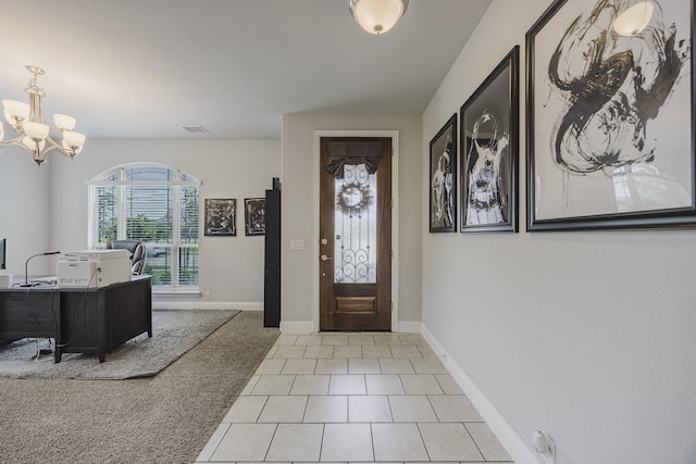 carpeted entryway featuring visible vents, baseboards, tile patterned floors, and an inviting chandelier
