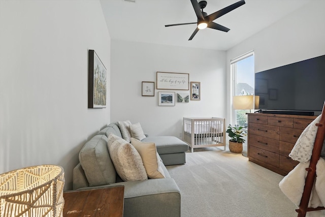 living room featuring a ceiling fan and carpet
