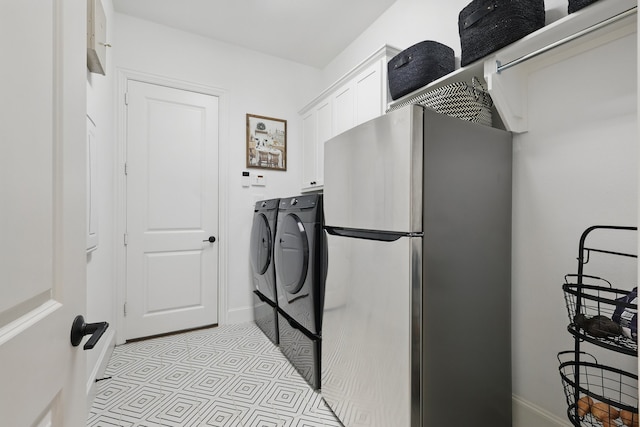 laundry area featuring baseboards and washing machine and dryer