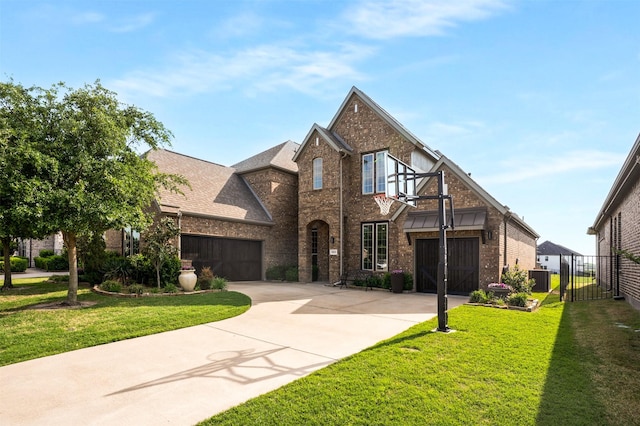 view of front of property featuring concrete driveway, brick siding, fence, and a front yard