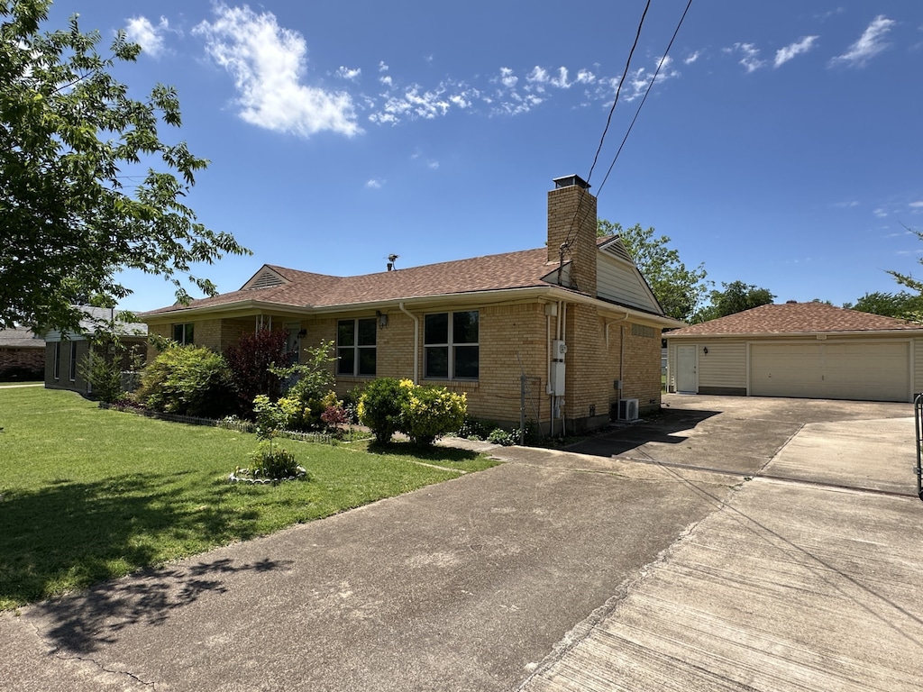 113 N Casa Grande Cir, Duncanville, TX 75116 - ranch-style house featuring a chimney, a front lawn, an outbuilding, brick siding, and roof with shingles