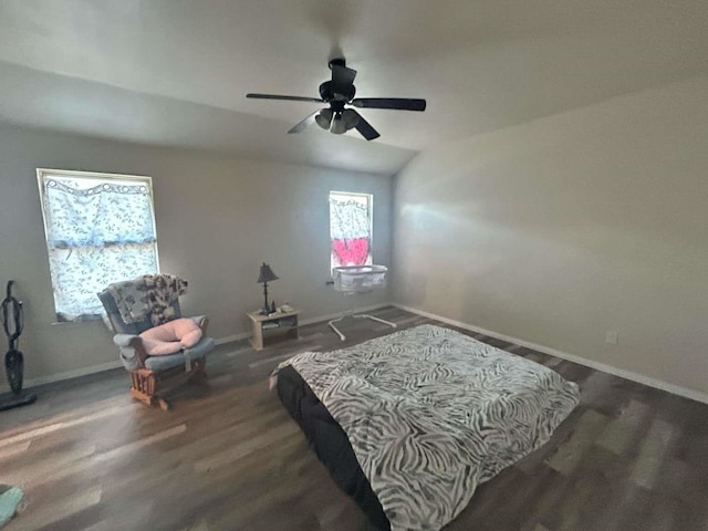 bedroom featuring lofted ceiling, wood finished floors, baseboards, and a ceiling fan