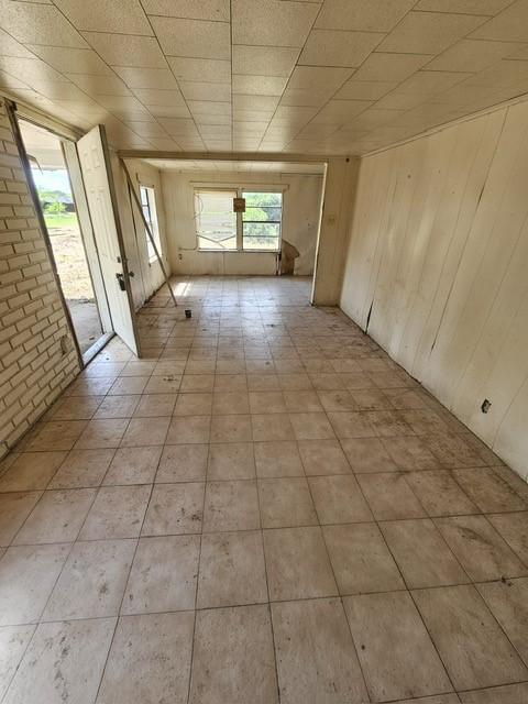 1726 County Road 279, Post Oak Bend, TX 75142 - spare room featuring wooden walls