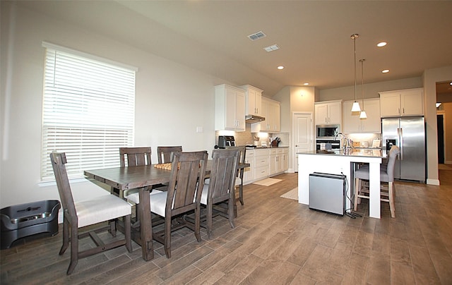 dining area featuring wood finished floors, visible vents, and recessed lighting