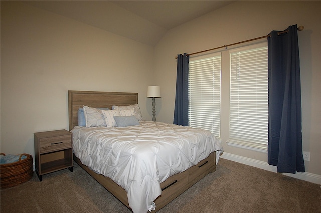 carpeted bedroom with vaulted ceiling and baseboards