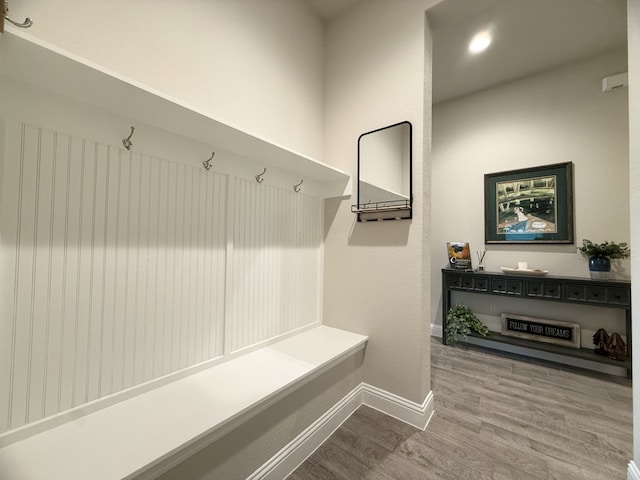mudroom with baseboards and wood finished floors