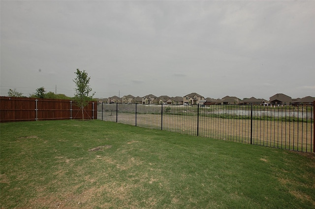 view of yard with a residential view and a fenced backyard