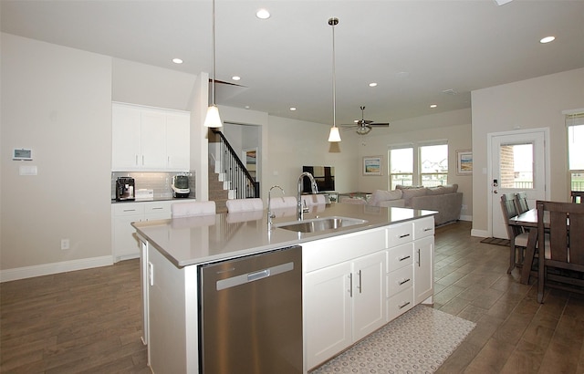 kitchen featuring open floor plan, dishwasher, dark wood-style floors, and a sink