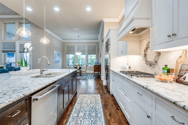 2500 Greenspoint Ln, Prosper, TX 75078 - kitchen with appliances with stainless steel finishes, a sink, custom range hood, dark wood-style flooring, and light stone countertops