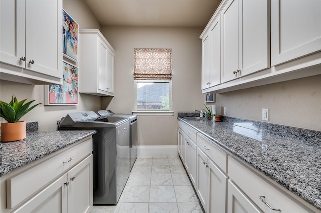 2500 Greenspoint Ln, Prosper, TX 75078 - washroom with washing machine and clothes dryer, cabinet space, light marble finish floors, and baseboards