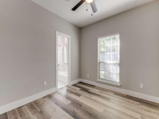 empty room with ceiling fan, baseboards, and wood finished floors