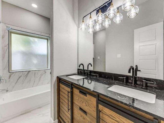 bathroom with double vanity, a washtub, marble finish floor, and a sink