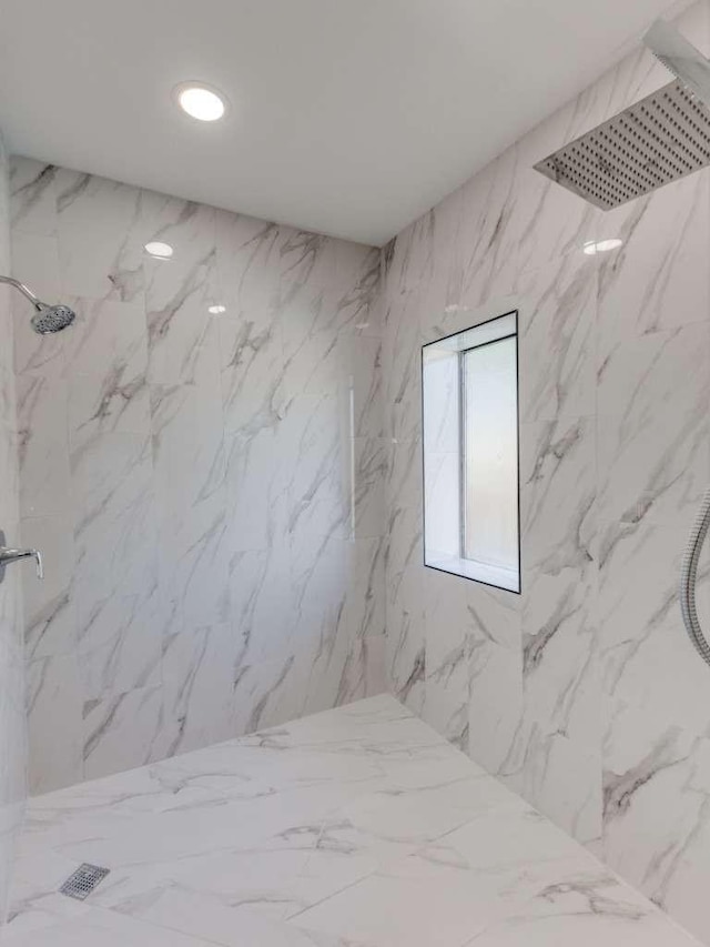 full bath with a marble finish shower