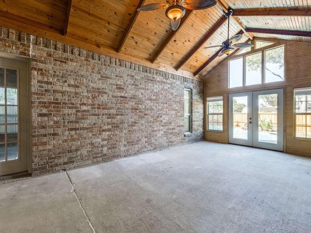 empty room featuring french doors, carpet, a ceiling fan, wooden ceiling, and high vaulted ceiling