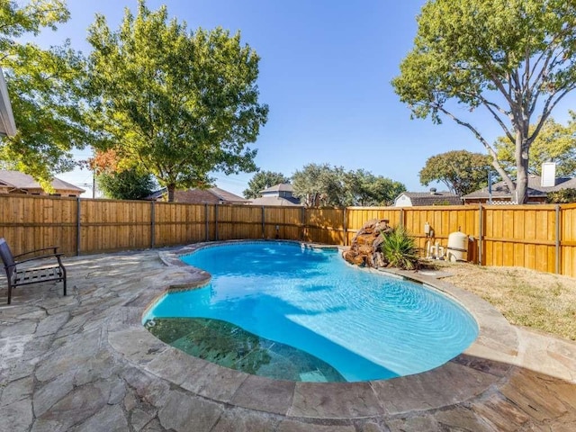 view of swimming pool with a fenced backyard, a patio area, and a fenced in pool