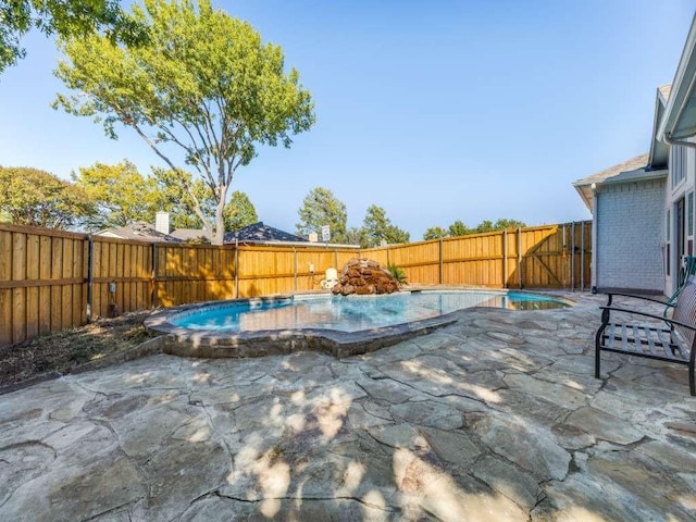 view of pool featuring a fenced backyard, a patio area, and a fenced in pool