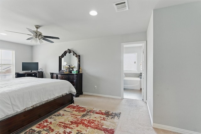 bedroom with baseboards, ensuite bath, ceiling fan, visible vents, and light colored carpet