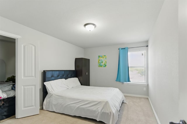 carpeted bedroom with baseboards
