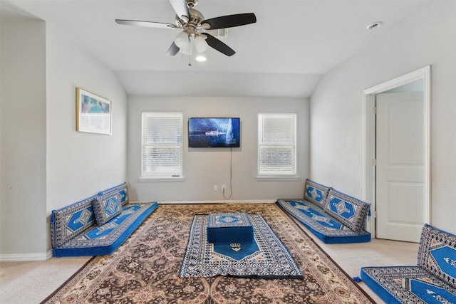 sitting room with vaulted ceiling, a wealth of natural light, and carpet flooring
