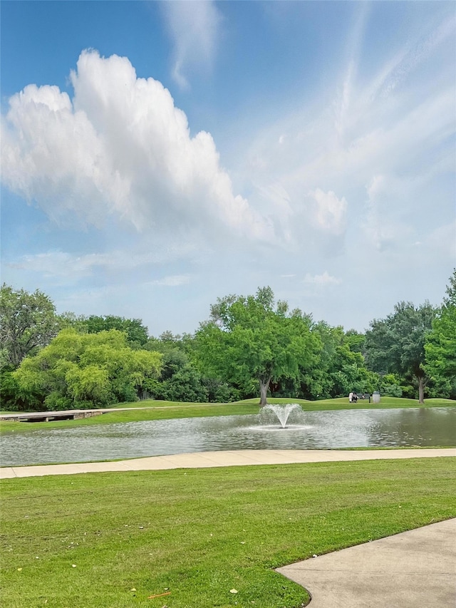 view of community featuring a water view and a lawn