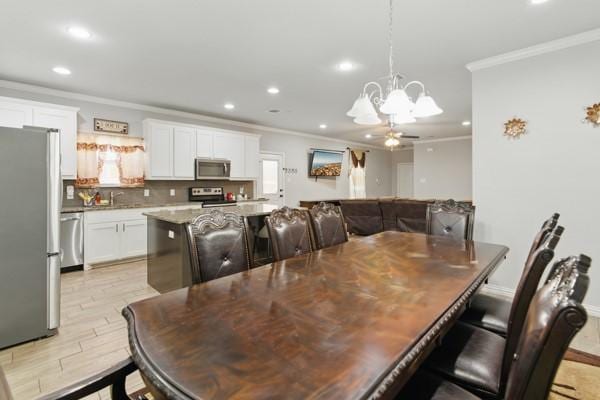 dining area with ornamental molding, a chandelier, and recessed lighting