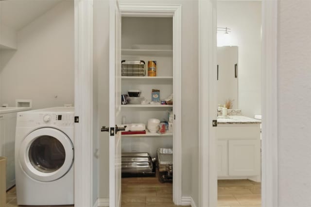 laundry area featuring light wood finished floors, washer / dryer, and laundry area