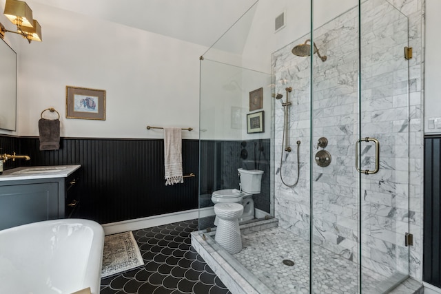 full bathroom with a freestanding bath, visible vents, vanity, wainscoting, and a stall shower