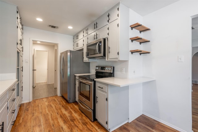 1904 Park Hill Dr, Arlington, TX 76012 - kitchen with light wood-style flooring, visible vents, baseboards, light countertops, and appliances with stainless steel finishes