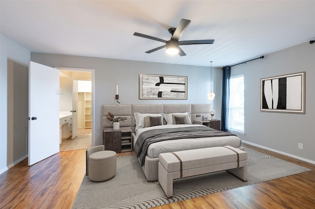 1904 Park Hill Dr, Arlington, TX 76012 - bedroom with light wood-style floors, baseboards, a ceiling fan, and ensuite bath