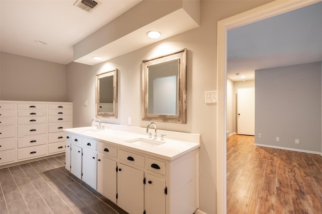 1904 Park Hill Dr, Arlington, TX 76012 - bathroom featuring visible vents, a sink, and wood finished floors