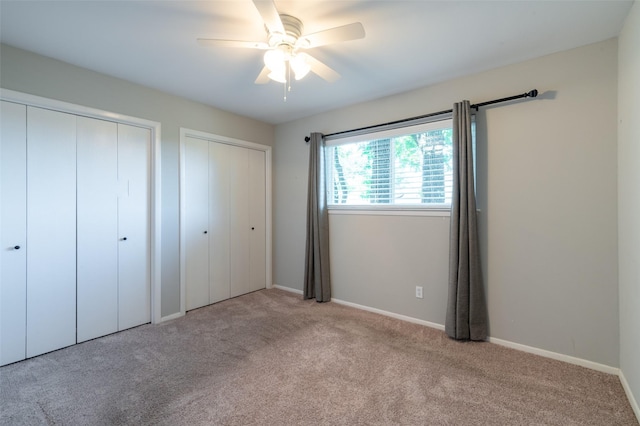1904 Park Hill Dr, Arlington, TX 76012 - unfurnished bedroom with two closets, carpet floors, baseboards, and ceiling fan